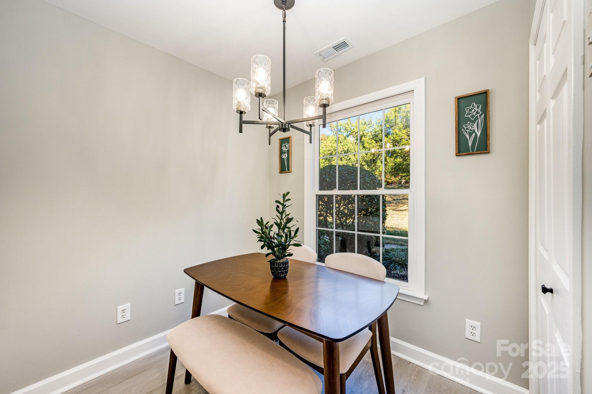 7047 Quail Hill Road Charlotte, NC 28210 - Photo 14 of 29 a view of a dining room with furniture window and wooden floor