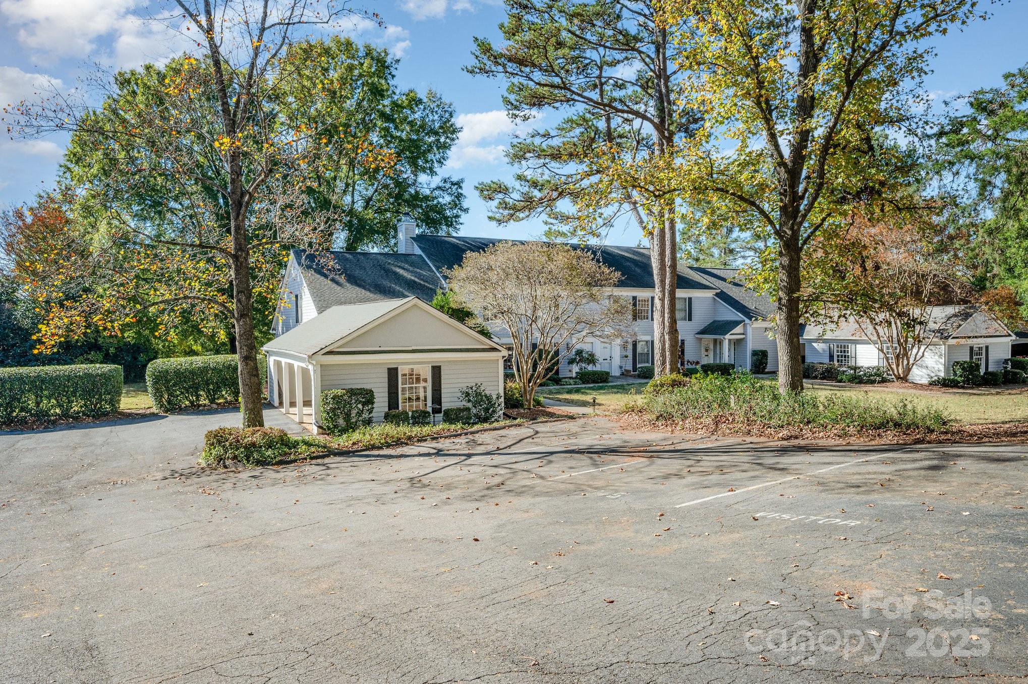 7047 Quail Hill Road Charlotte, NC 28210 - Photo 5 of 29 a front view of a house with a yard and large trees
