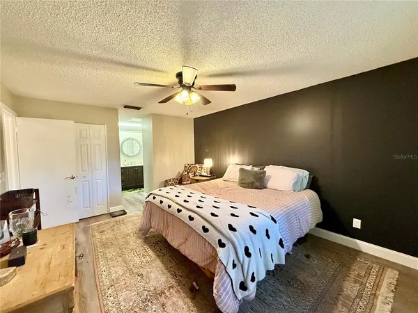 a bedroom with a bed and a chandelier