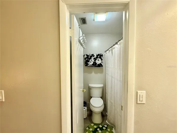 a bathroom with a toilet and a mirror