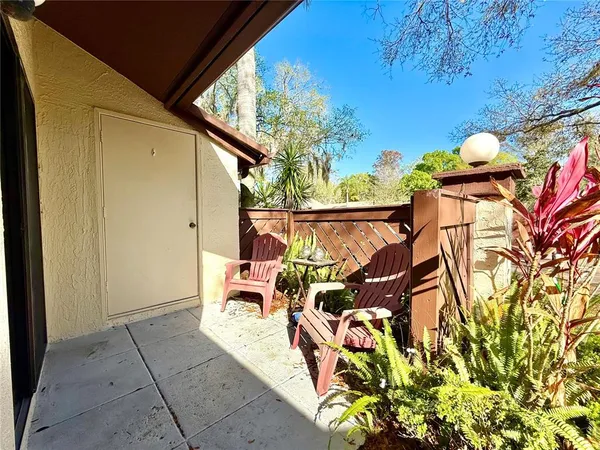 a view of a patio with table and chairs and potted plants
