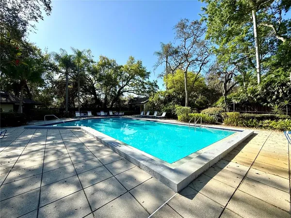 a view of a backyard with swimming pool