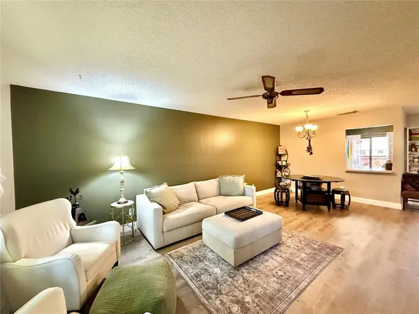 a living room with furniture and a lamp