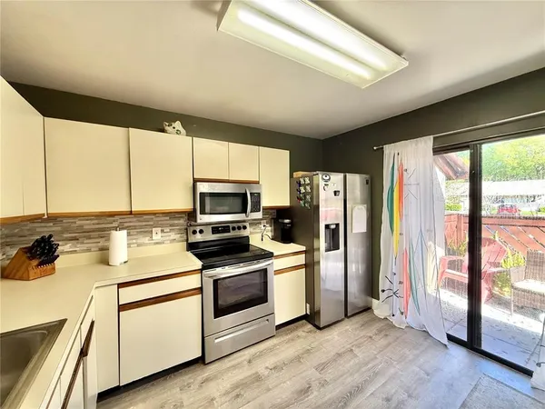 a kitchen with a refrigerator stove and sink
