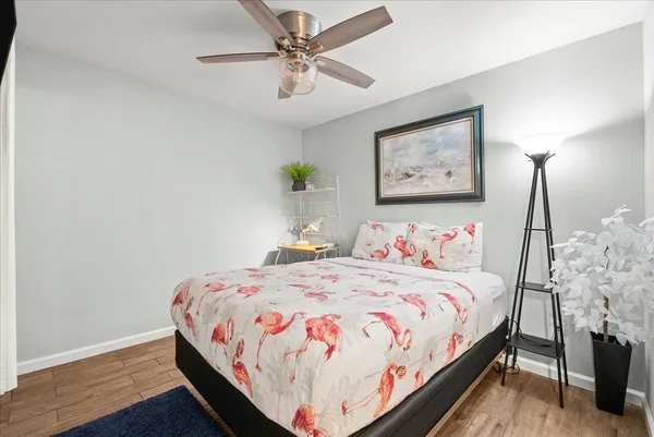 a bedroom with bed and a chandelier