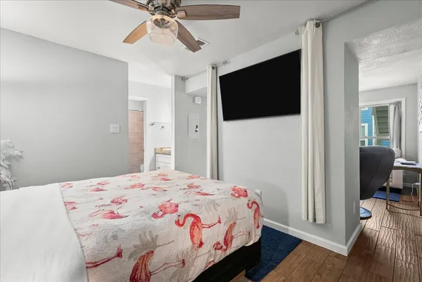 a bedroom with a bed and a flat screen tv