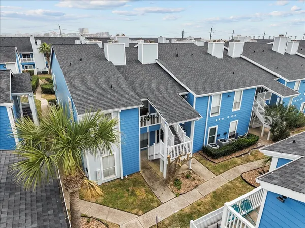 an aerial view of a house with balcony and patio