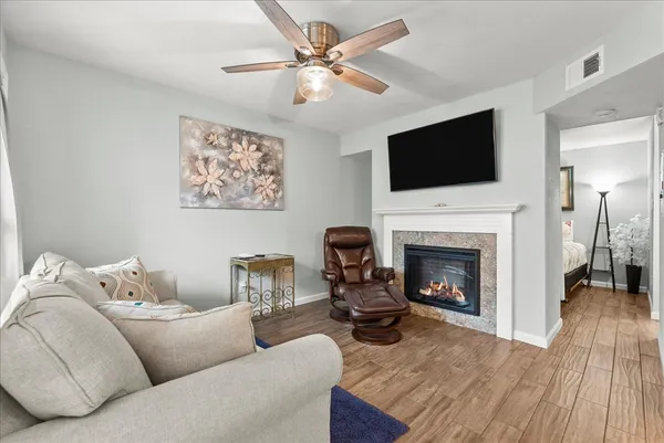 a living room with furniture a fireplace and a flat screen tv