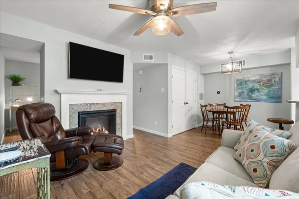 a living room with furniture fireplace and flat screen tv