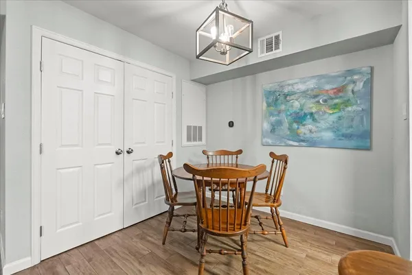 a view of a dining room with furniture wooden floor and a window