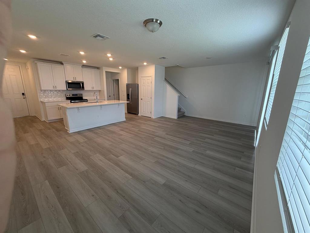 4264 Ranch House Road St. Cloud, FL 34772 - Photo 9 of 34 a view of kitchen with kitchen island wooden floor and center island