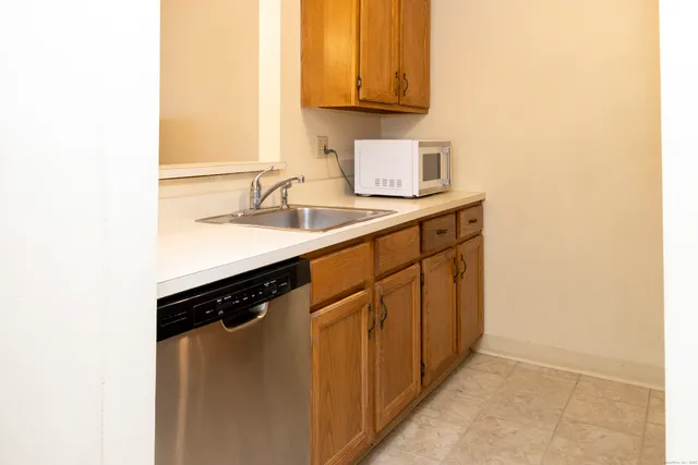 a kitchen with stainless steel appliances a sink and a cabinets