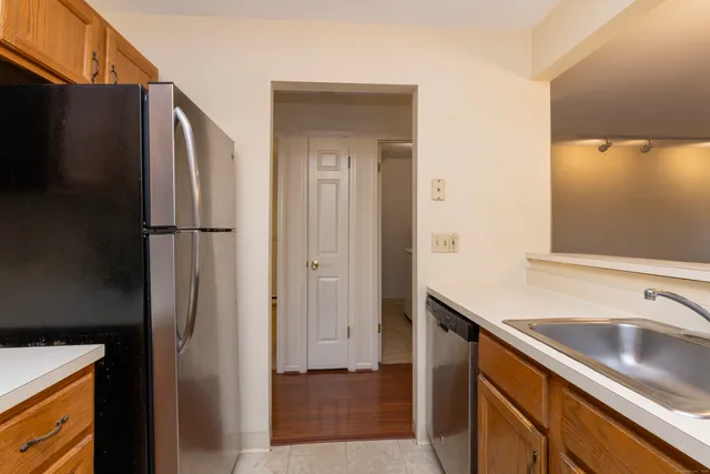 a kitchen with stainless steel appliances granite countertop a refrigerator and a sink