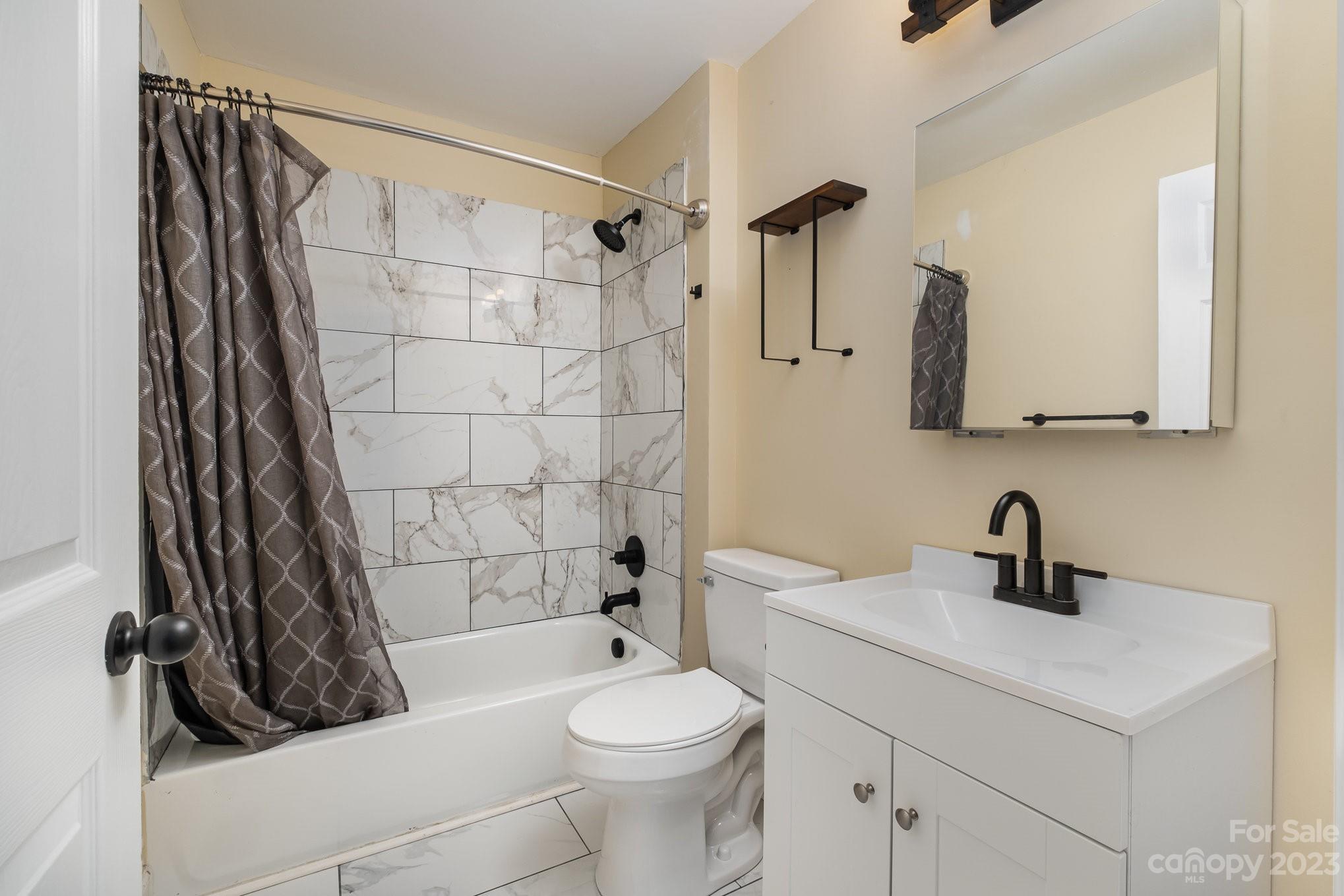 260 Upper Stanley Road Stanley, NC 28164 - Photo 11 of 18 a bathroom with a sink a toilet and shower