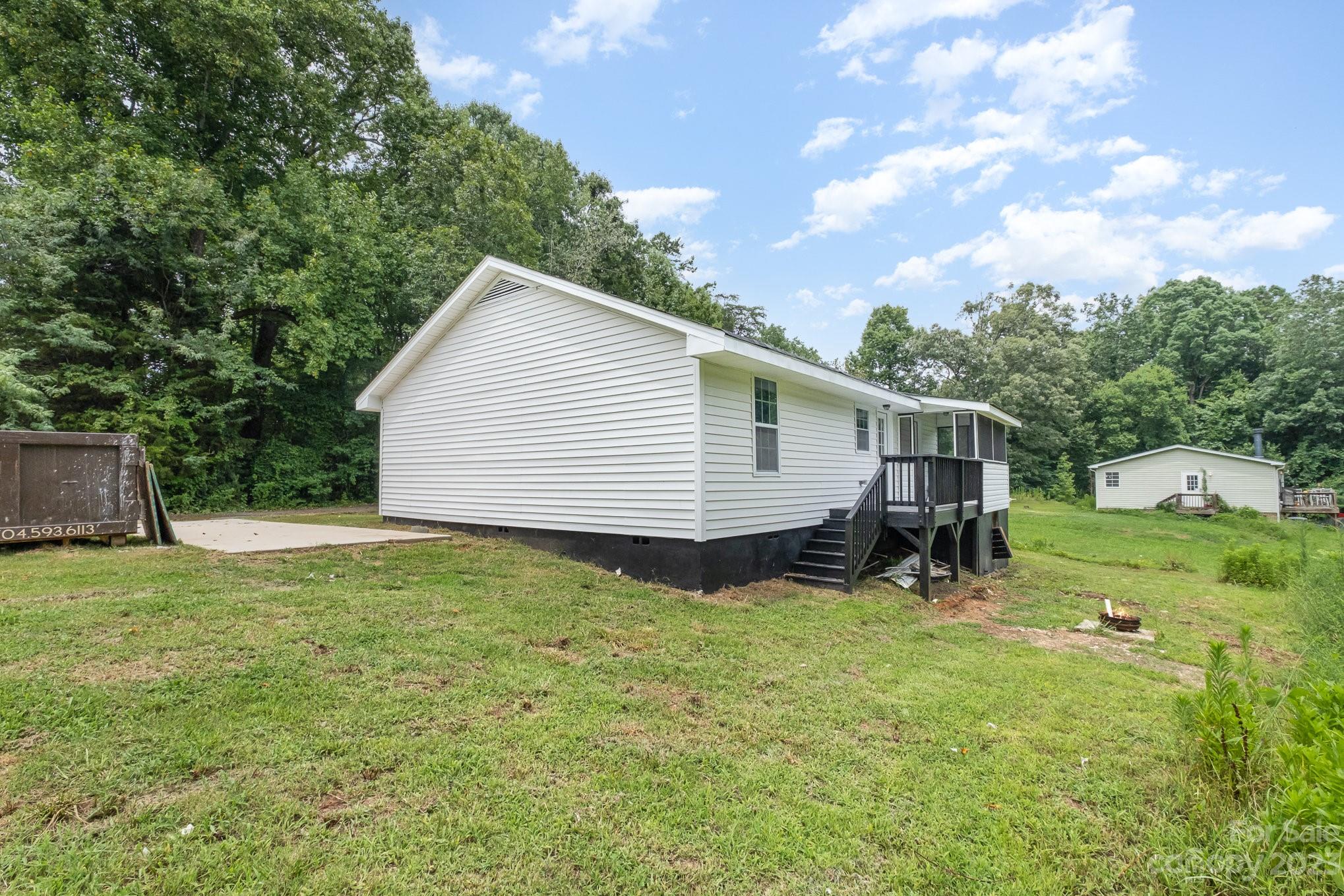 260 Upper Stanley Road Stanley, NC 28164 - Photo 16 of 18 a backyard of a house with table and chairs