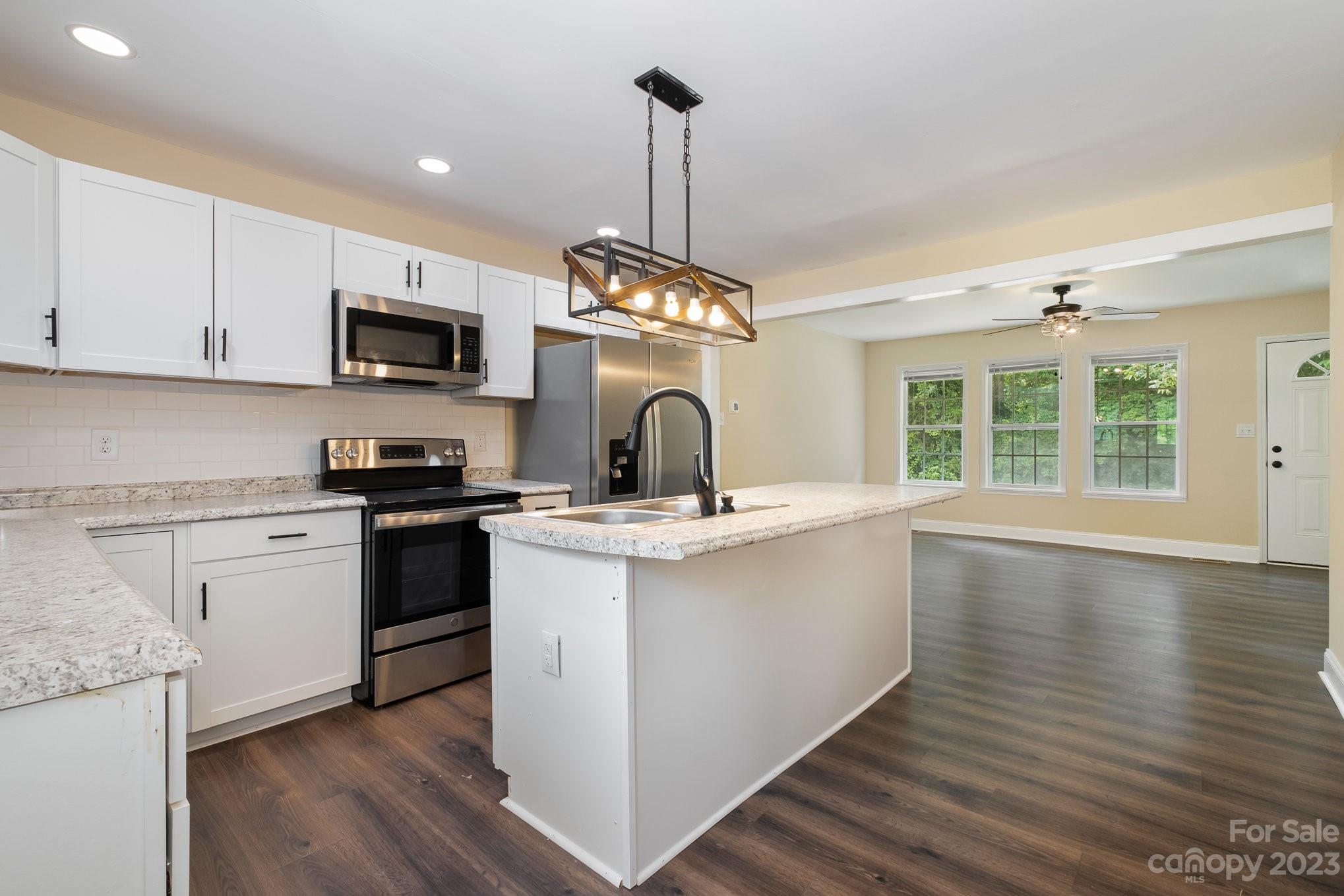260 Upper Stanley Road Stanley, NC 28164 - Photo 7 of 18 a kitchen with stainless steel appliances granite countertop a sink stove and refrigerator