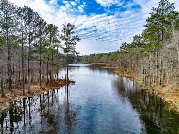 a lake view with wooden fence and lake view