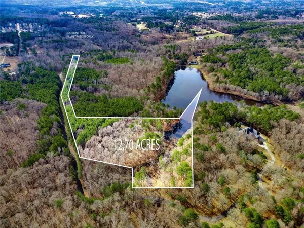 an aerial view of a house with a yard and lake view