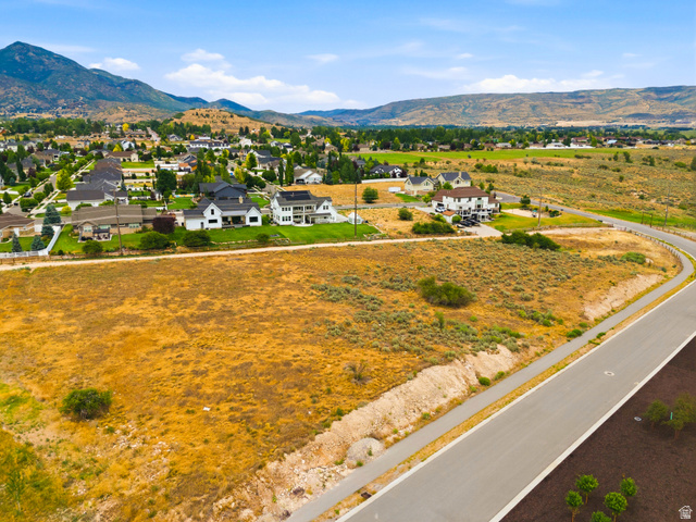 574 South Fox Den Road, Unit 3 Midway, UT 84049 - Photo 38 of 45 Expansive undeveloped parcel featuring a paved road, curbing, and established landscaping