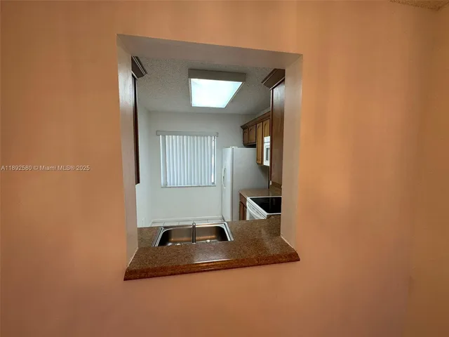 a kitchen with a sink and a mirror