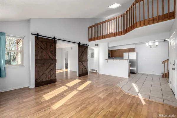 a view of a hallway with wooden cabinet and a kitchen