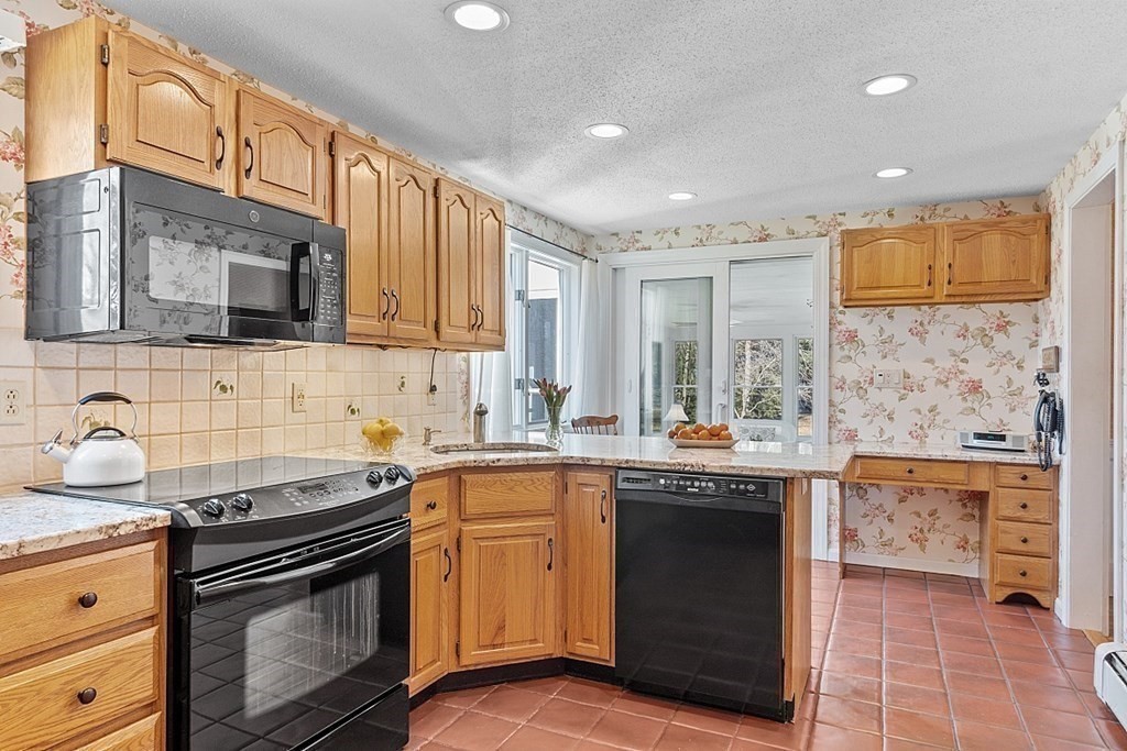25 Strawberry Hill Road Andover, MA 01810 - Photo 18 of 38 a kitchen with a sink stove and cabinets