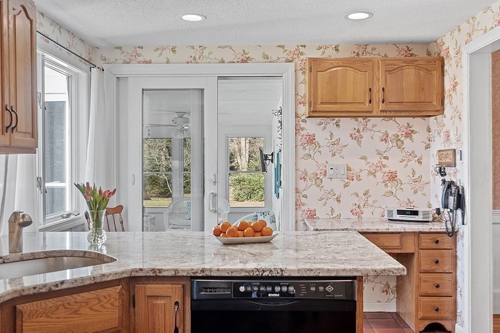 25 Strawberry Hill Road Andover, MA 01810 - Photo 19 of 38 a kitchen with granite countertop a sink and a stove