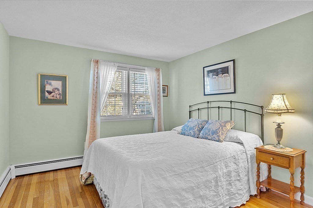 25 Strawberry Hill Road Andover, MA 01810 - Photo 26 of 38 a bedroom with a bed and a lamp on dresser