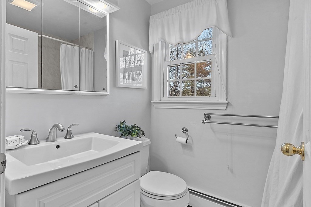 25 Strawberry Hill Road Andover, MA 01810 - Photo 29 of 38 a bathroom with a sink a mirror and a toilet