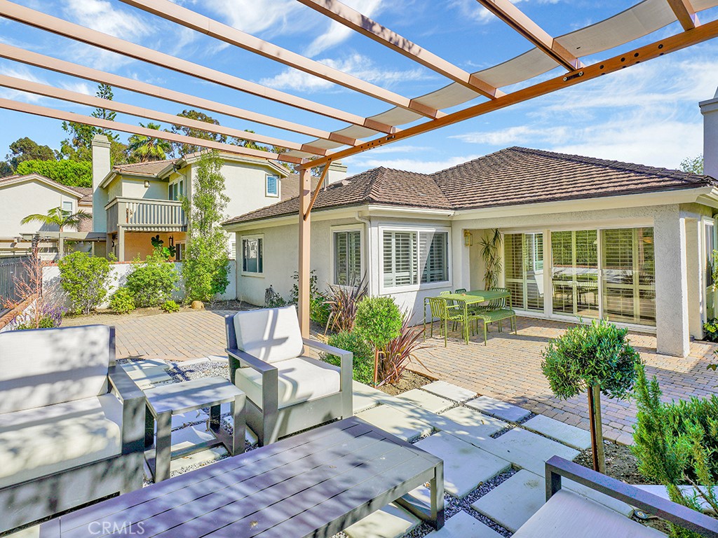 24941 Danamaple Dana Point, CA 92629 - Photo 11 of 32 a view of a house with backyard sitting area and garden