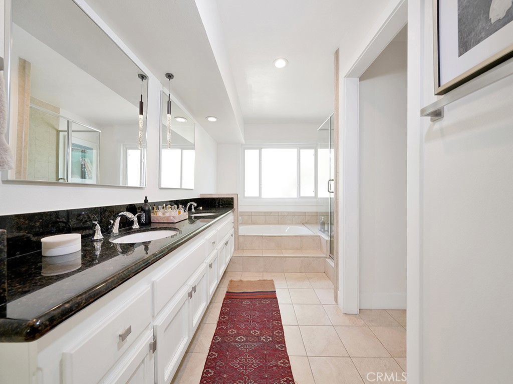 24941 Danamaple Dana Point, CA 92629 - Photo 16 of 32 a large white kitchen with a sink and cabinets