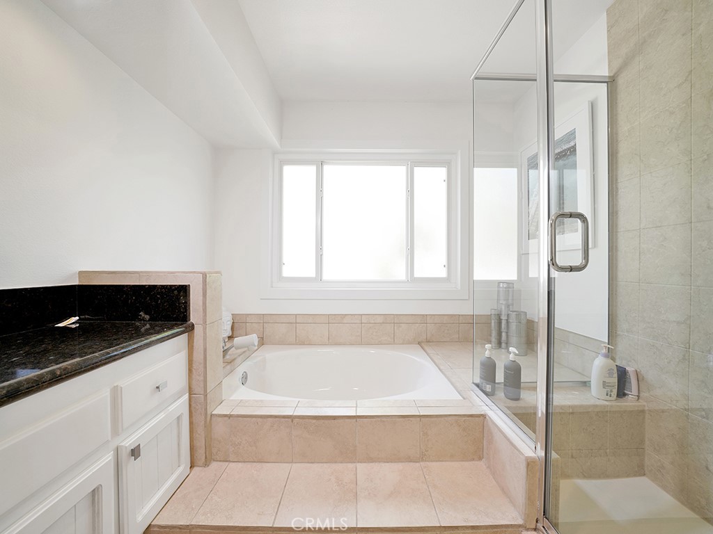 24941 Danamaple Dana Point, CA 92629 - Photo 17 of 32 a spacious bathroom with a tub sink and mirror
