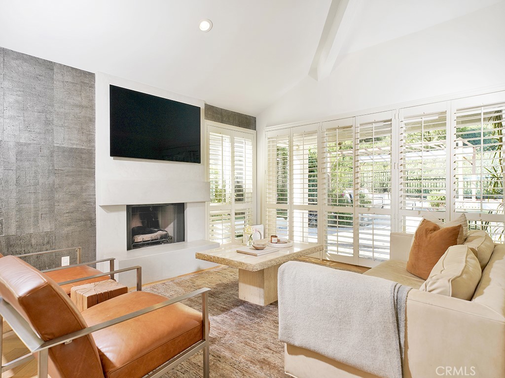 24941 Danamaple Dana Point, CA 92629 - Photo 4 of 32 a living room with furniture fireplace and a flat screen tv