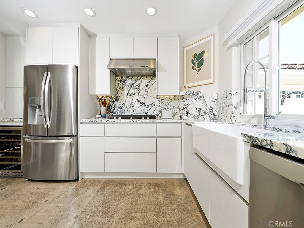 24941 Danamaple Dana Point, CA 92629 - Photo 8 of 32 a kitchen with a refrigerator and a sink