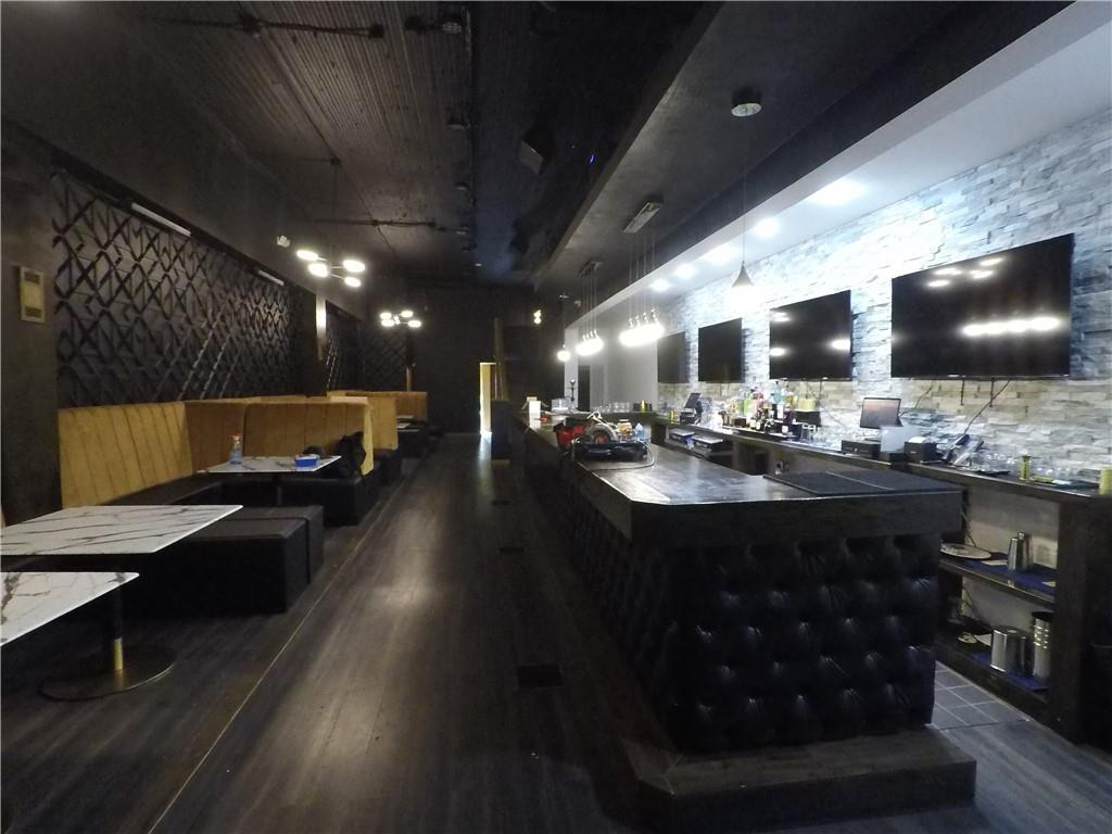 251 Trinity Avenue Southwest Atlanta, GA 30303 - Photo 10 of 32 a living room with stainless steel appliances kitchen island granite countertop furniture a rug and a kitchen view