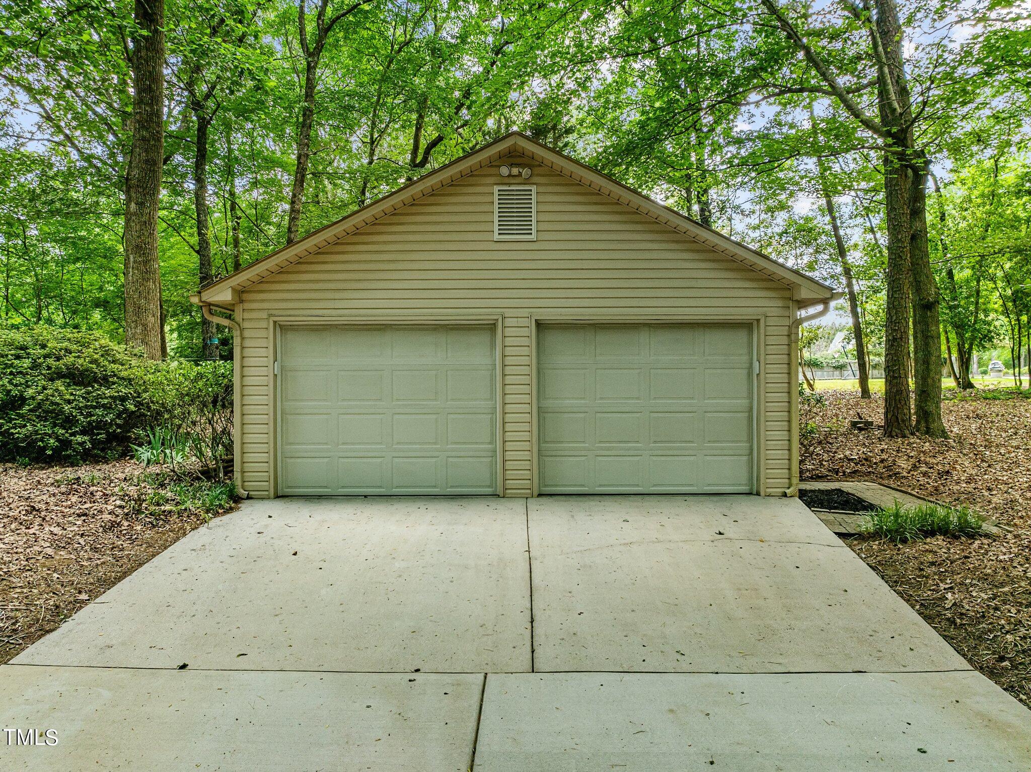 8413 Bournemouth Drive Raleigh, NC 27615 - Photo 13 of 94 a front view of a house with garage