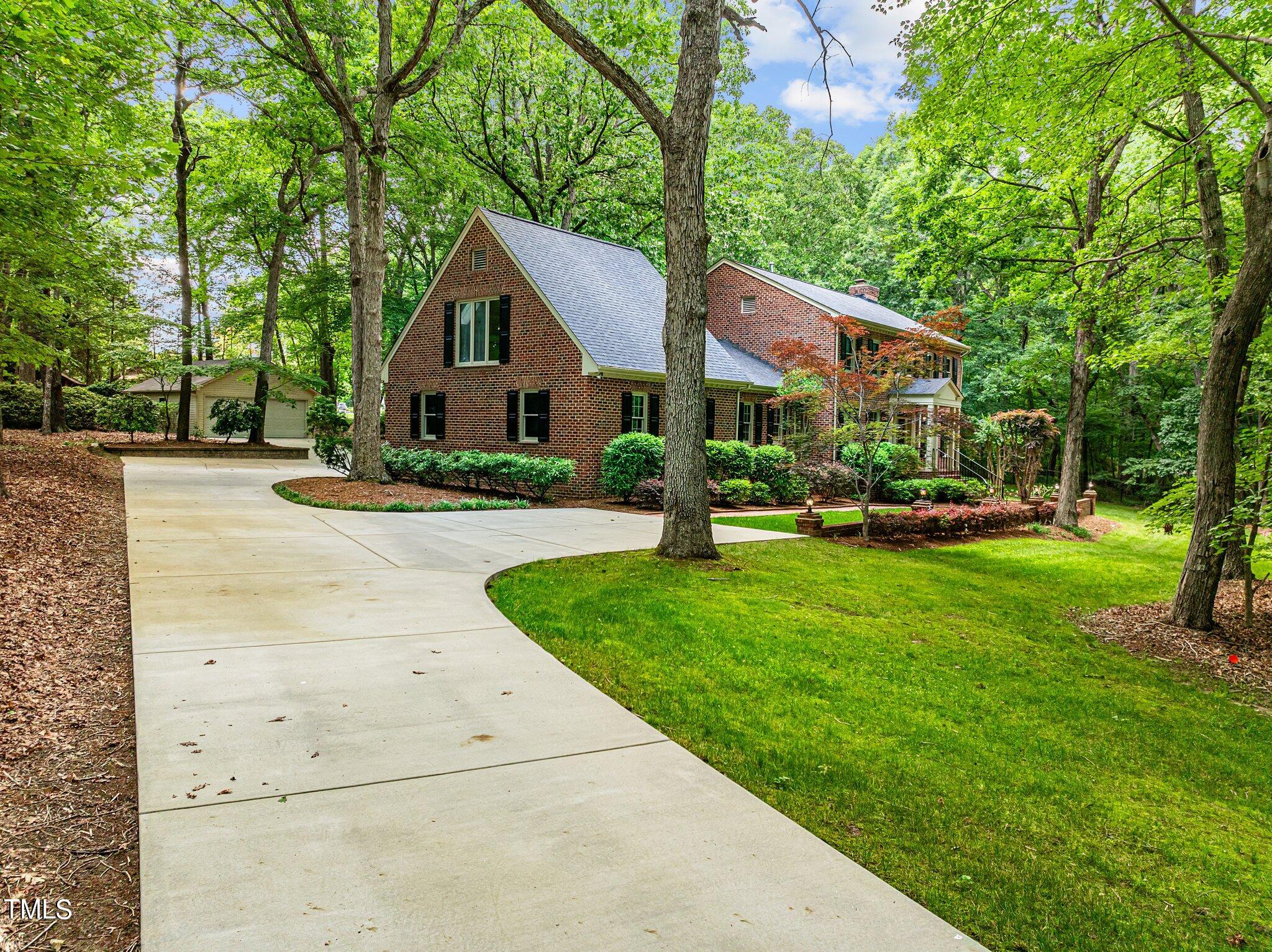 8413 Bournemouth Drive Raleigh, NC 27615 - Photo 15 of 94 a front view of a house with a yard and trees