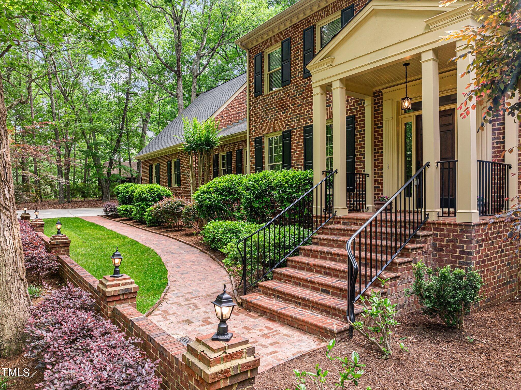 8413 Bournemouth Drive Raleigh, NC 27615 - Photo 18 of 94 a front view of a house with a garden