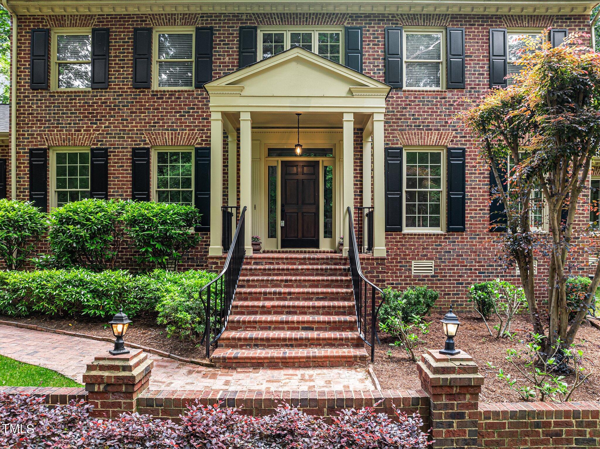 8413 Bournemouth Drive Raleigh, NC 27615 - Photo 20 of 94 a front view of a house with a yard