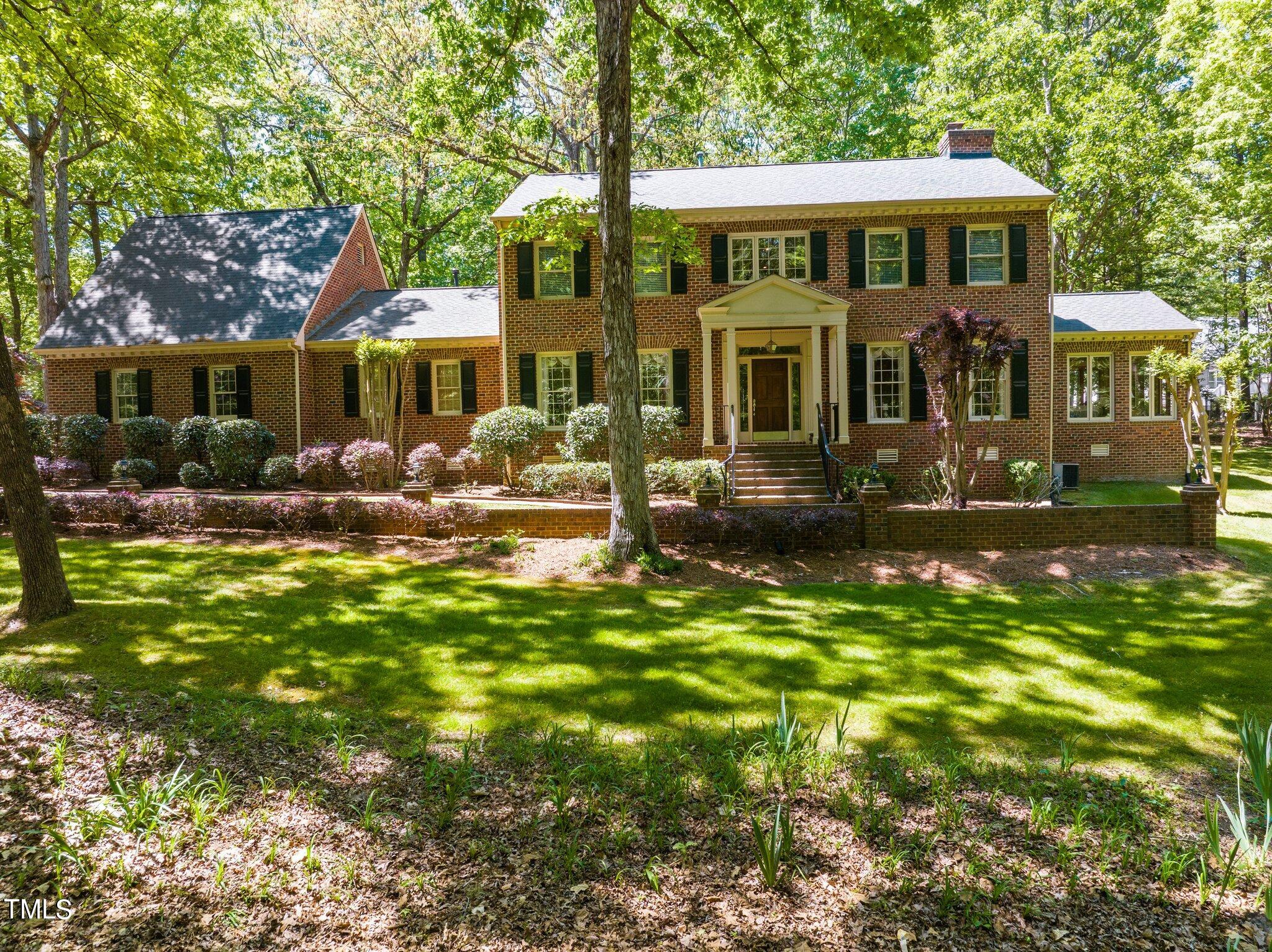 8413 Bournemouth Drive Raleigh, NC 27615 - Photo 3 of 94 a front view of a house with a yard