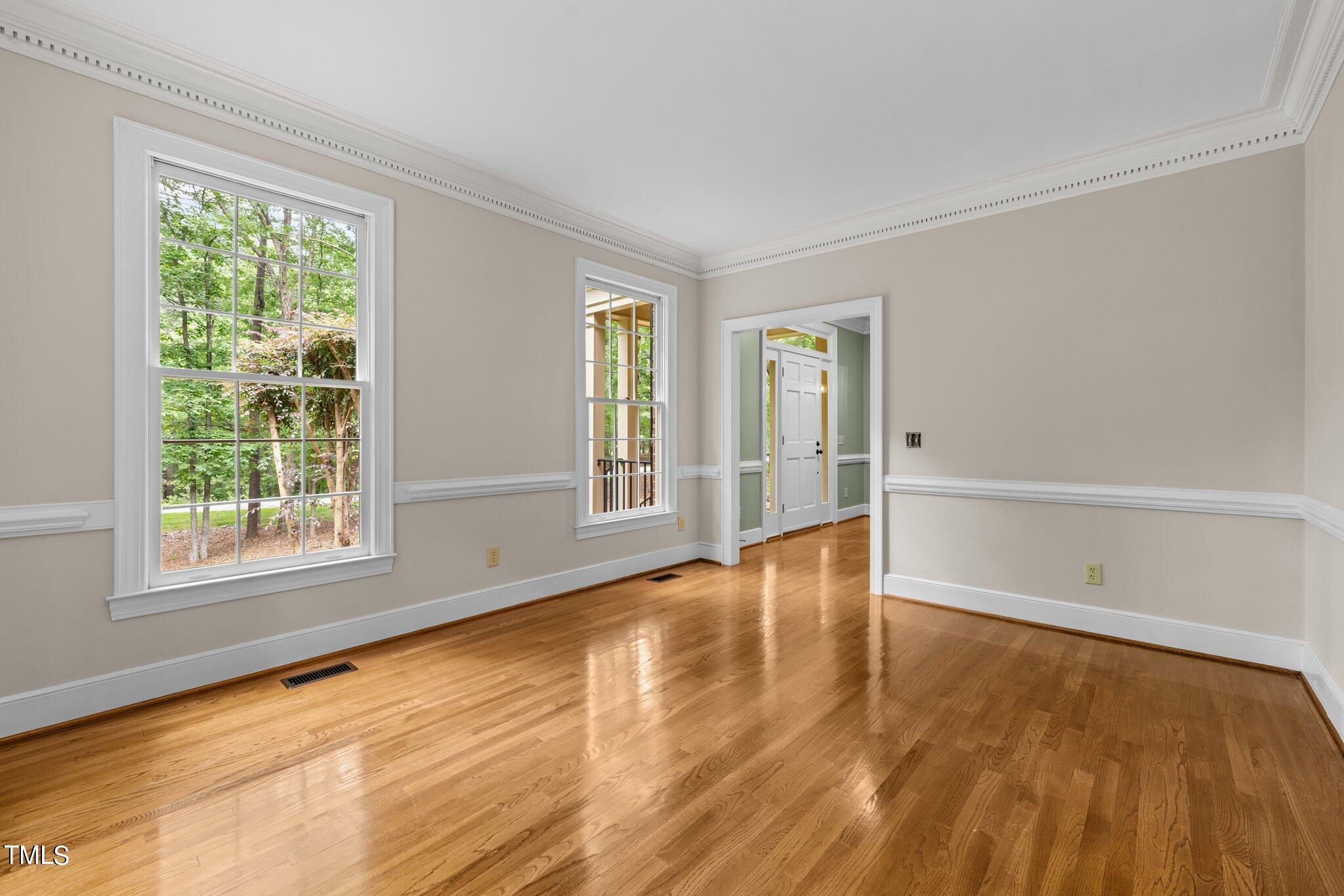 8413 Bournemouth Drive Raleigh, NC 27615 - Photo 34 of 94 a view of an empty room with wooden floor and a window