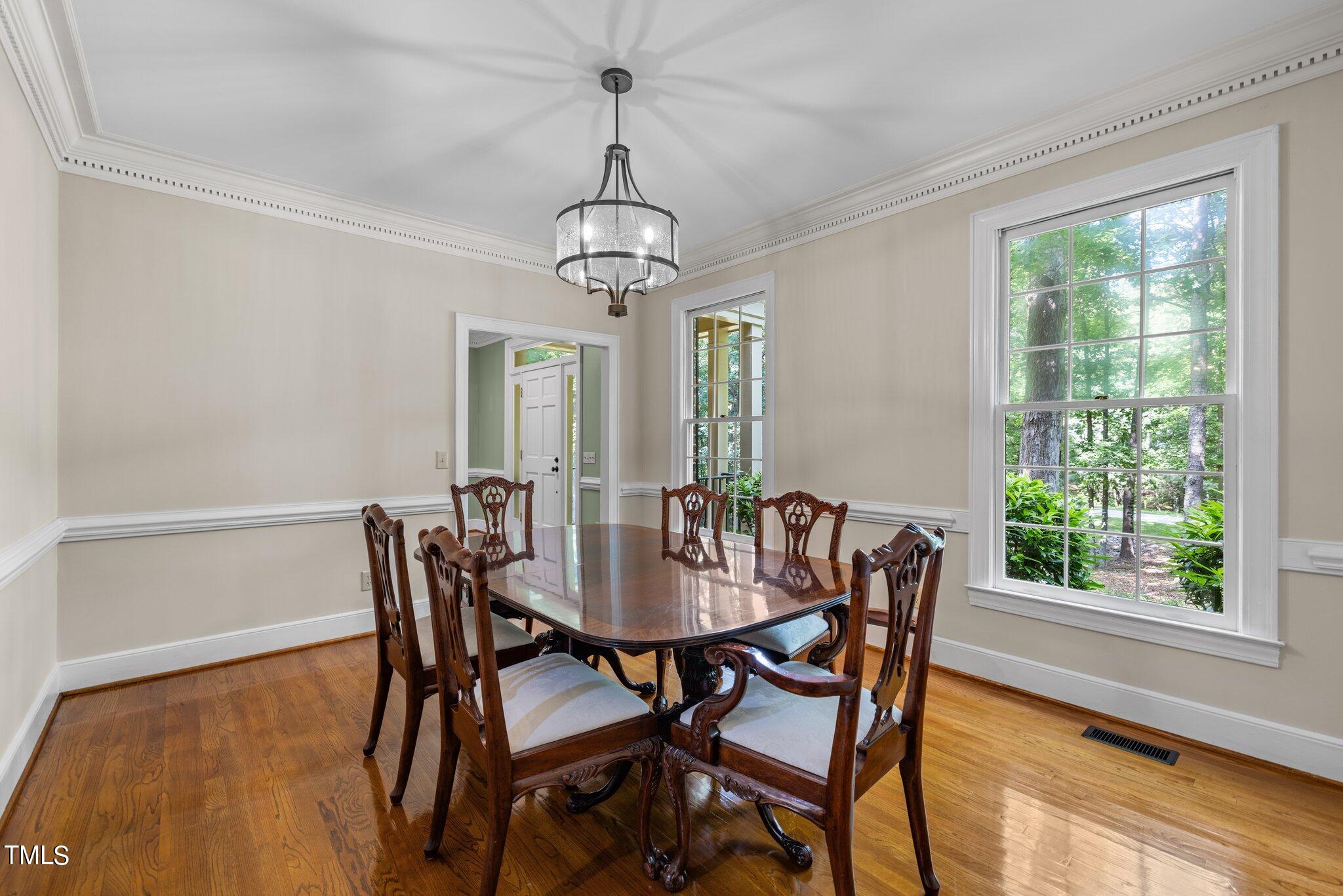8413 Bournemouth Drive Raleigh, NC 27615 - Photo 38 of 94 a view of a dining room with furniture window and outside view