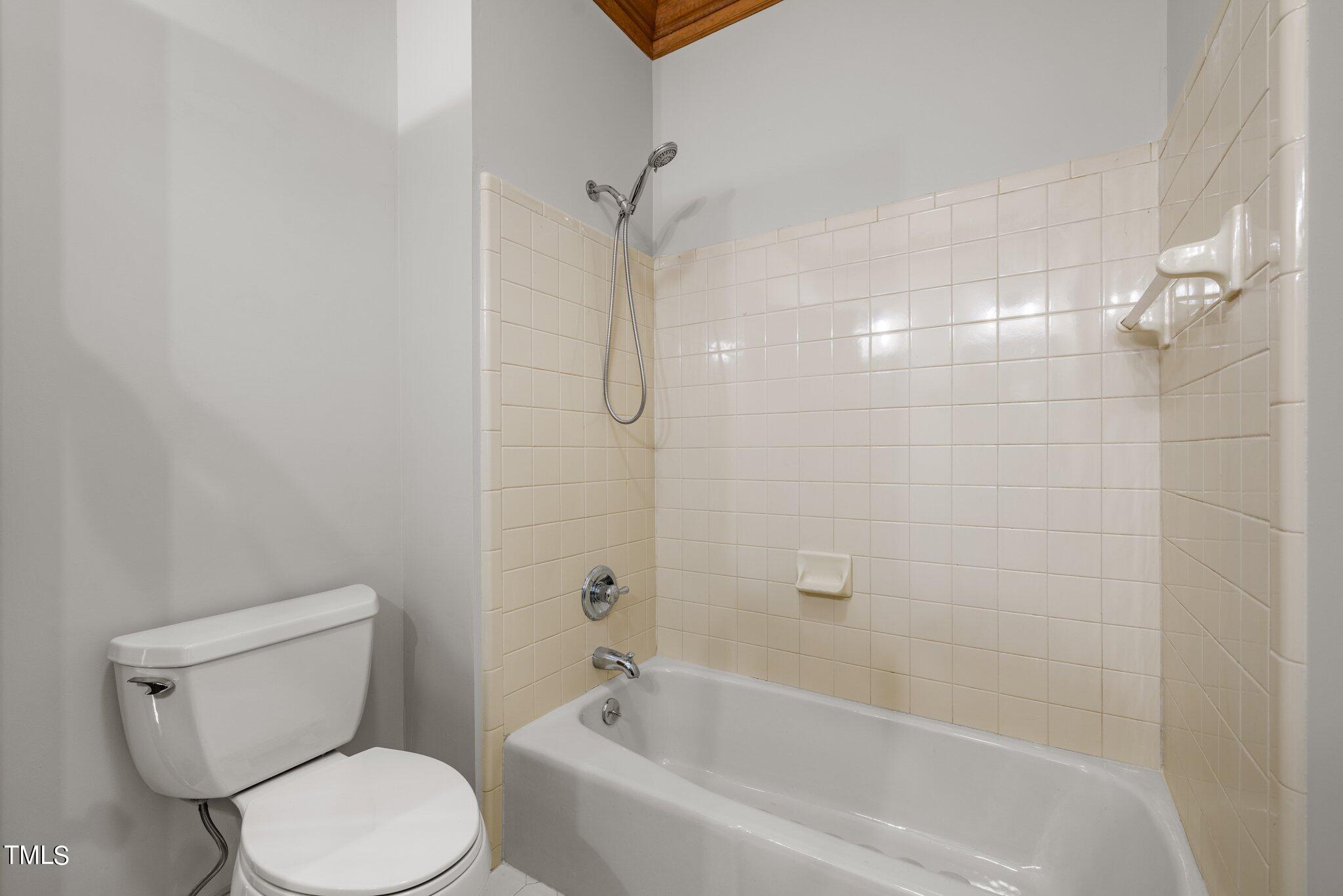 8413 Bournemouth Drive Raleigh, NC 27615 - Photo 43 of 94 a white toilet sitting next to a bath tub