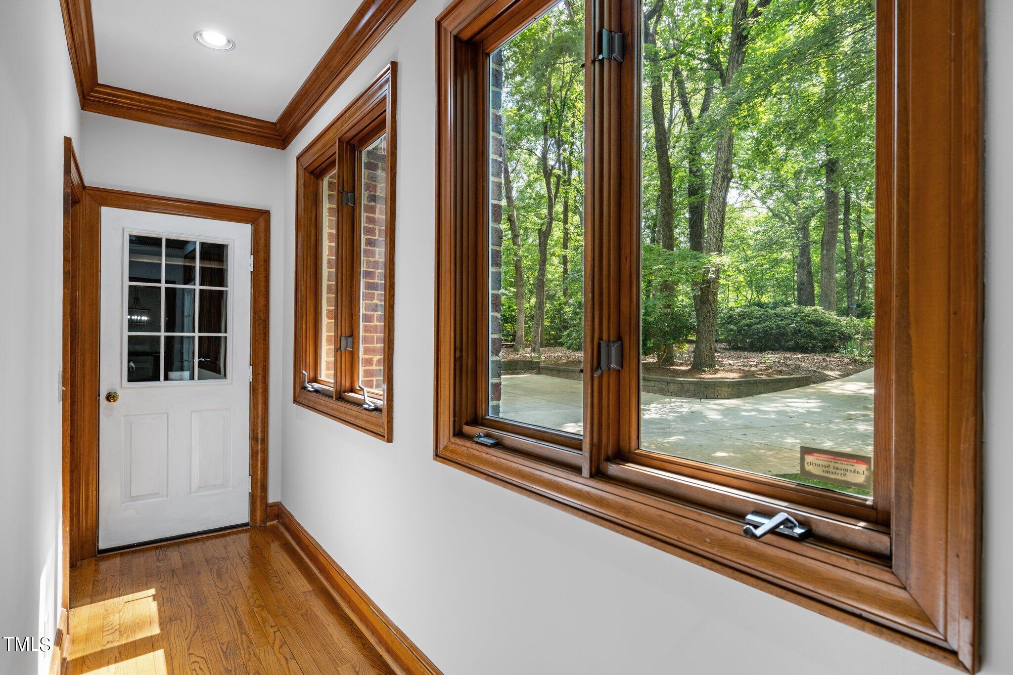 8413 Bournemouth Drive Raleigh, NC 27615 - Photo 44 of 94 a view of a room with a large window and wooden floor