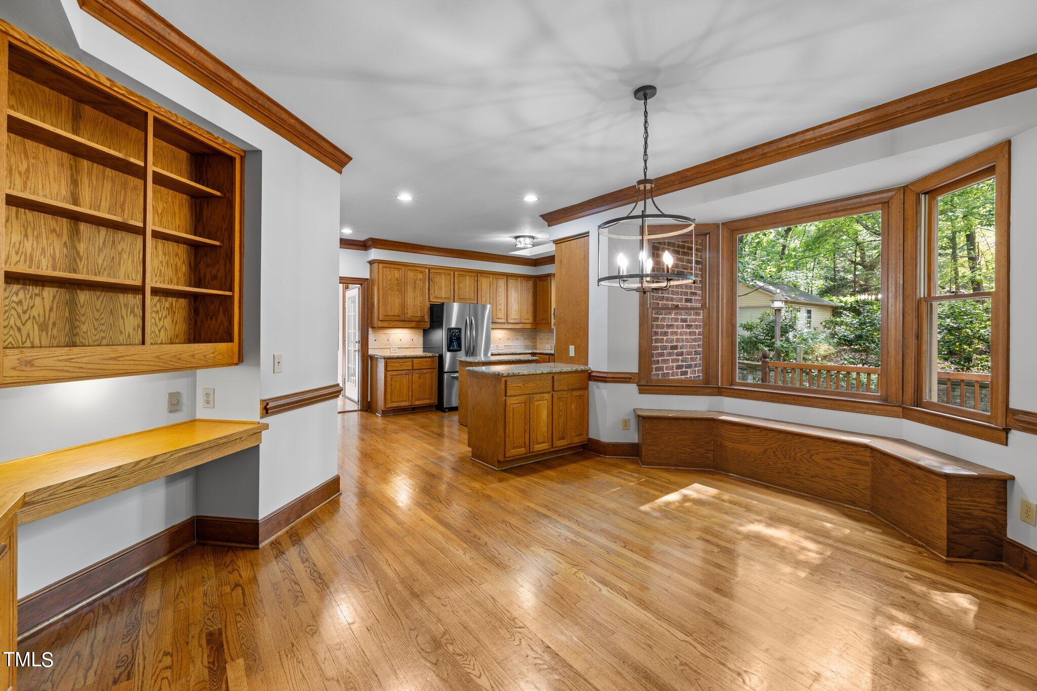 8413 Bournemouth Drive Raleigh, NC 27615 - Photo 54 of 94 a kitchen with stainless steel appliances granite countertop a sink and a refrigerator