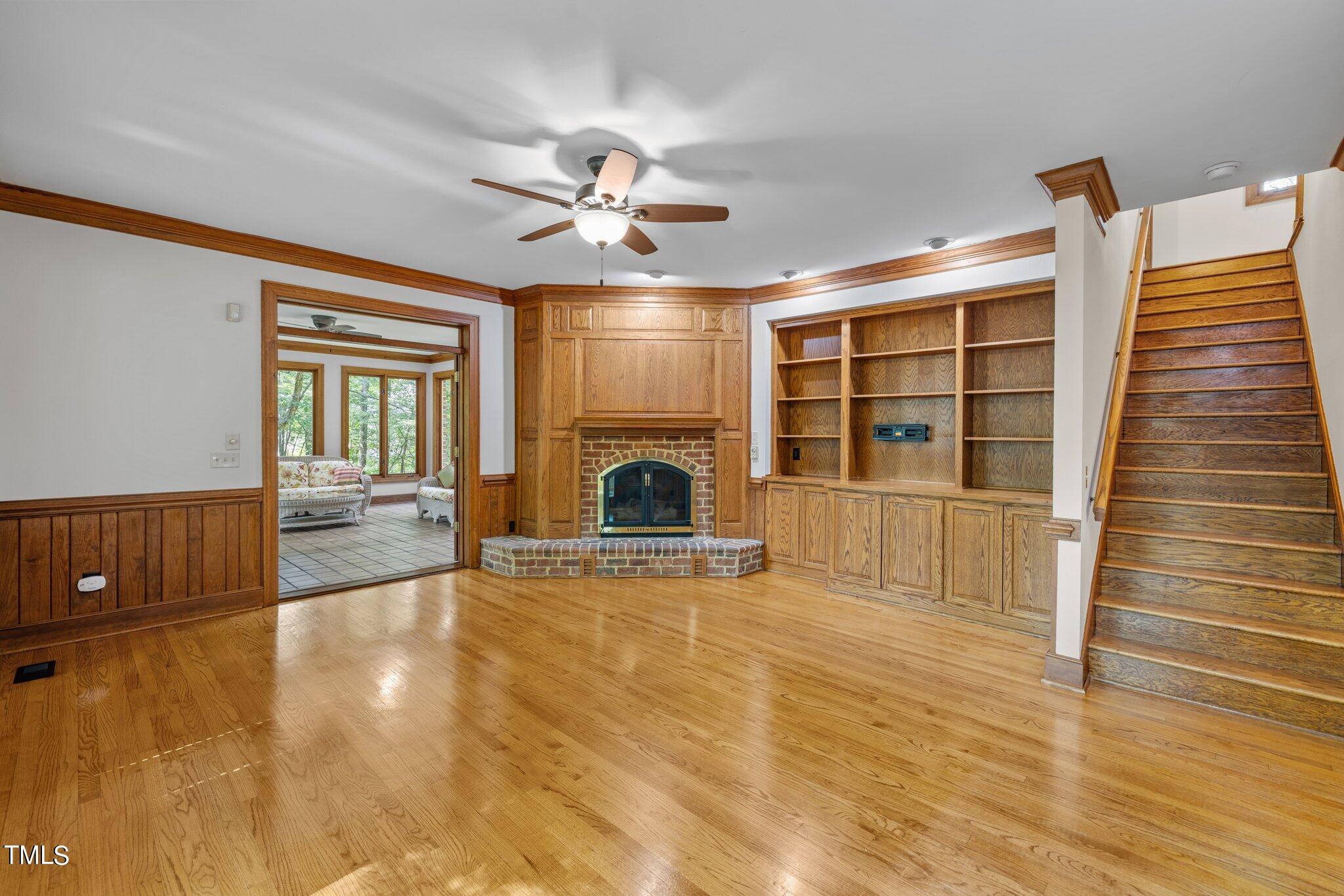 8413 Bournemouth Drive Raleigh, NC 27615 - Photo 57 of 94 a view of empty room with fireplace and wooden floor