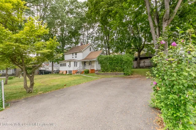 a view of house with outdoor space and trees