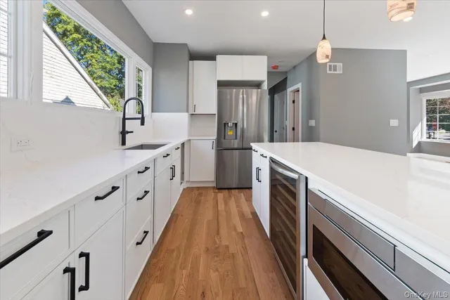 a kitchen with granite countertop a sink and a stove top oven