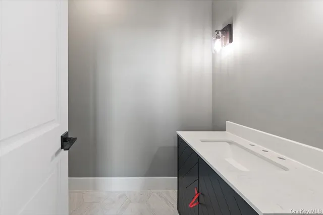 a bathroom with a sink vanity and tub
