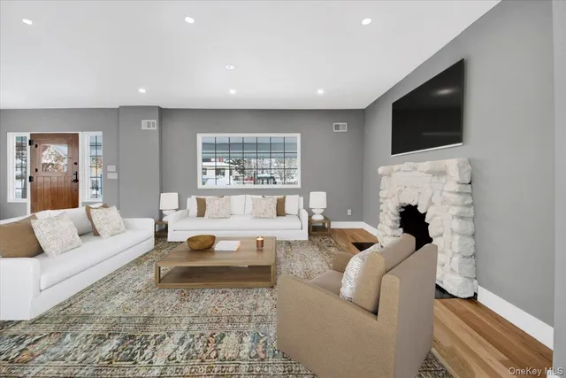 a living room with fireplace furniture and a flat screen tv